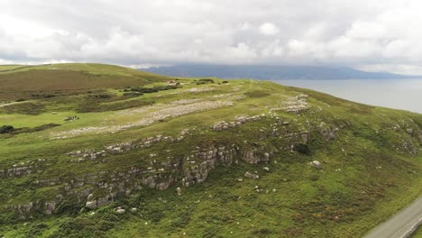 aerial view flying above great orme llandudno mountain valley rise over rural landscape