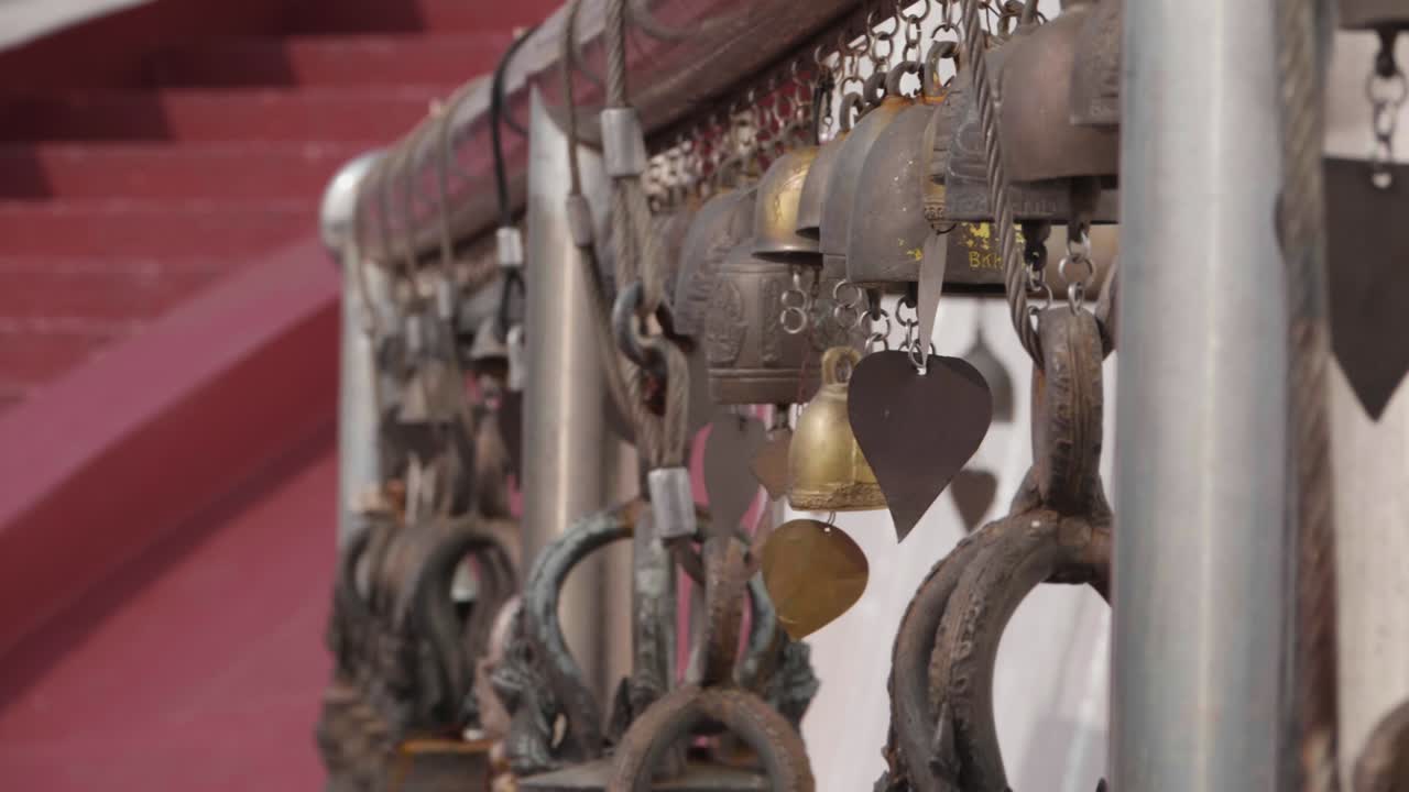 Bells Swinging in the Wind at Buddhist Temple. Near Focus. Slow Motion.
