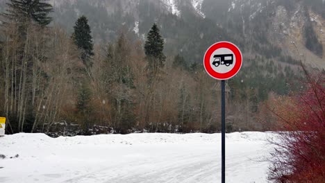 long view of a camping car sign with snowy and trees in the background