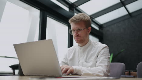 man is working in modern office of big successful company lawyer or financial consultant with laptop