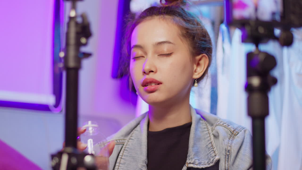 A young woman enjoys a refreshing sip of water showcasing the importance of hydration in daily life.