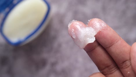 close-up of petroleum jelly on fingers