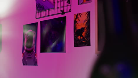 close up of a wall with posters of a galaxy, an astronaut, and a jungle scene