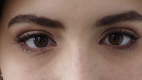 cerca de los ojos de una mujer joven mirando a la cámara parpadeando
