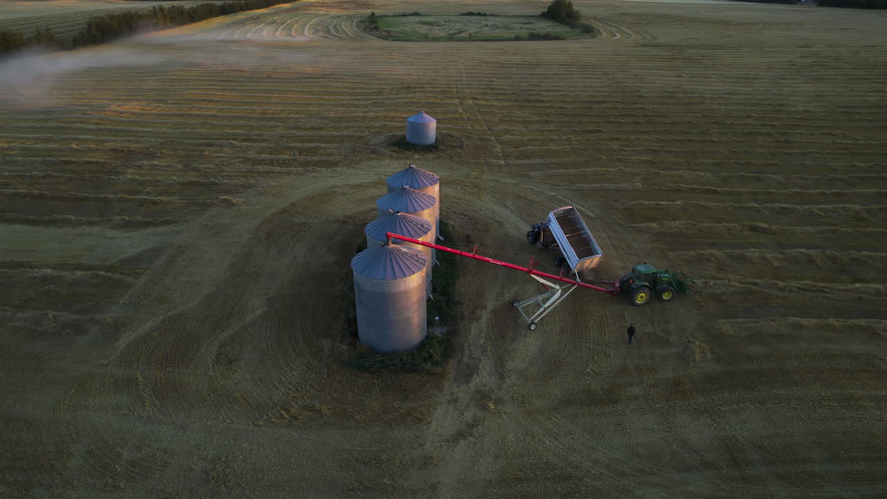 Grain Silos And Tractors In Red Deer County, Alberta, Canada - Drone Shot
