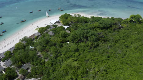 Fishing-village-on-tropical-jungle-ocean-coast-with-anchored-boats