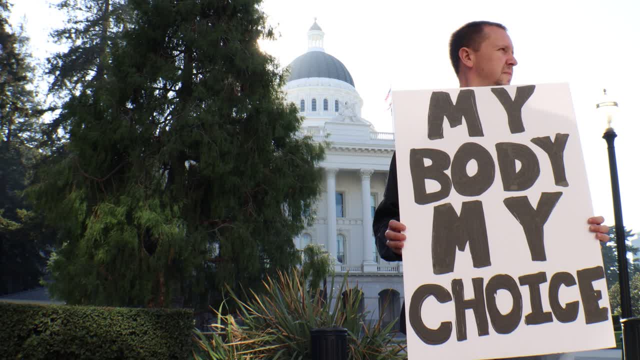 Male Political Protester with My Body My Choice Sign