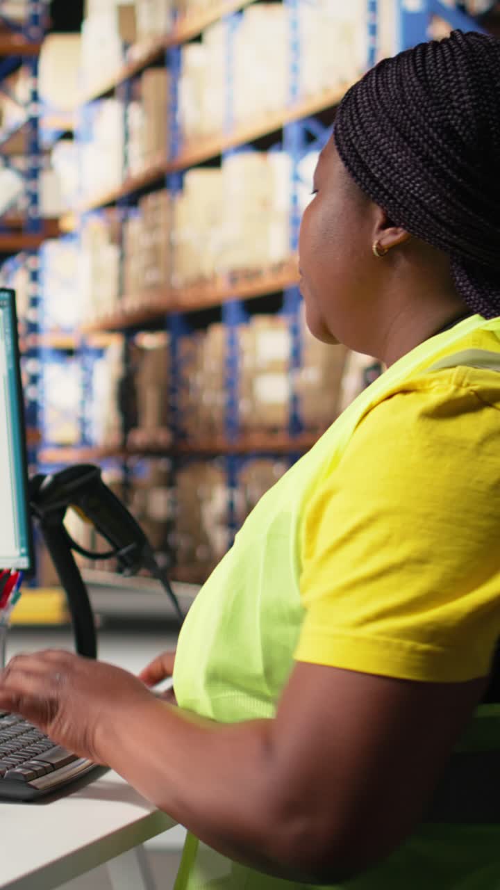 Vertical Video African american worker processing e-commerce cargo orders in warehouse setting