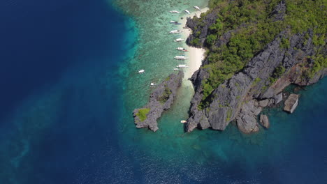 Dynamic-Establishing-aerial-of-Bangka-boats-beached-on-Palawan-island