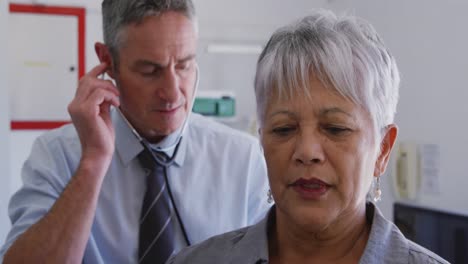 doctor examining a senior woman in a retirement home