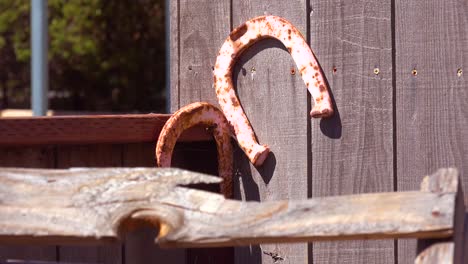 horseshoes are nailed to a wall at a dude ranch farm in santa barbara california