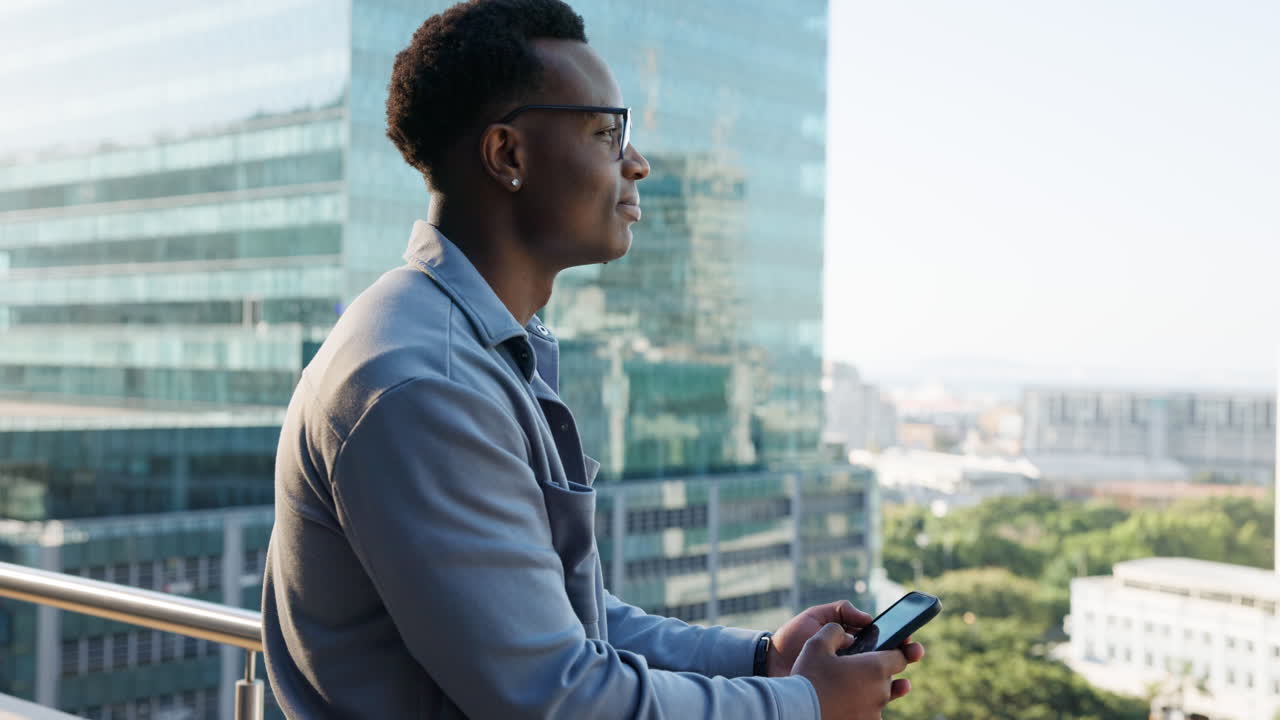 Man on a balcony with city view