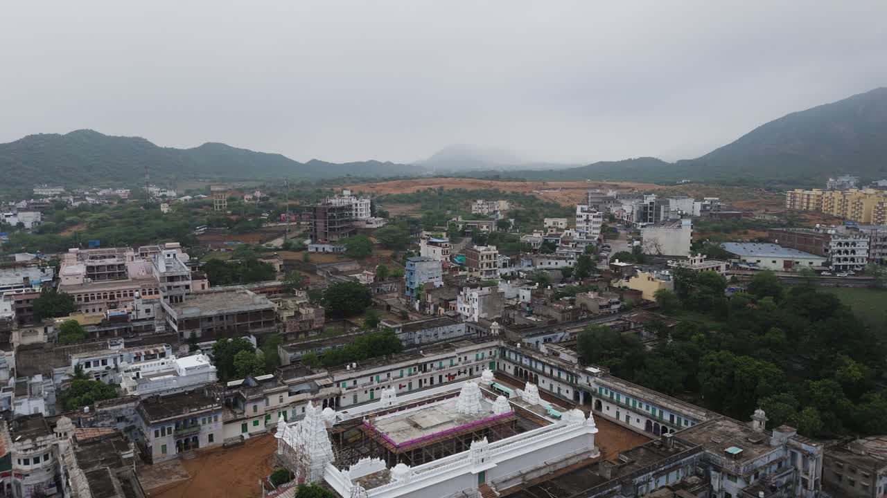 Ancient holy pilgrimage city Pushkar temple drone fly over. India