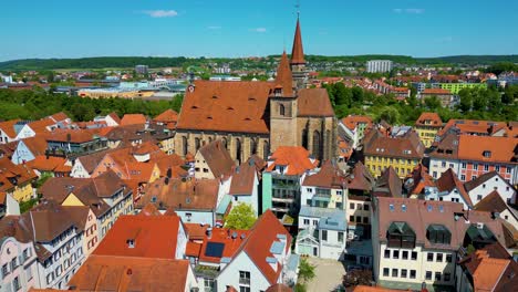 4k aerial drone video of the historic st. johannis church in the old town area of downtown ansbach, germany