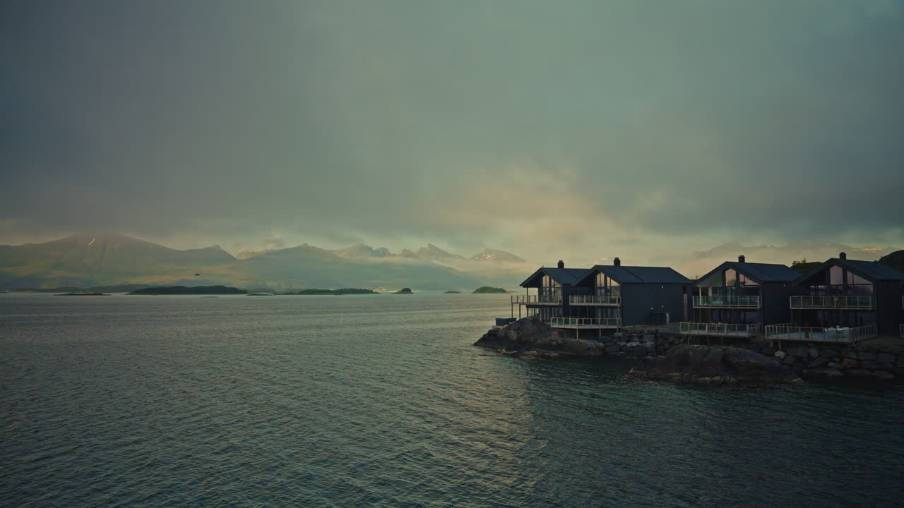 Timelapse of the Norwegian Fjords at sunset in the Lofoten Islands, Norway. View of the traveling clouds and the picturesque nordic landscape.