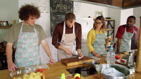 chef and students cooking together on culinary class