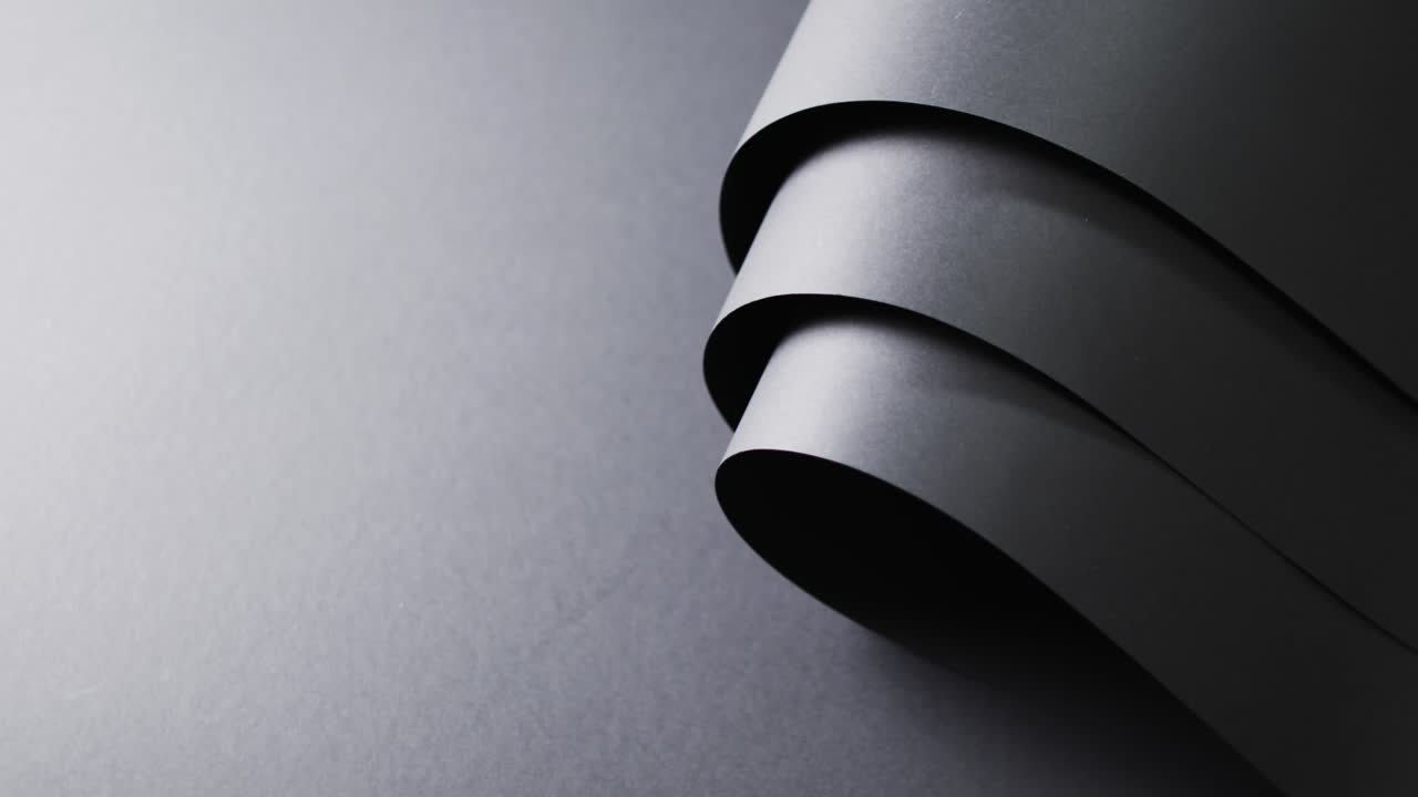 Close up of rolls of black paper and copy space on black background