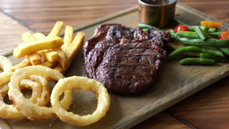 medium rare beef steak with vegetable and french fries