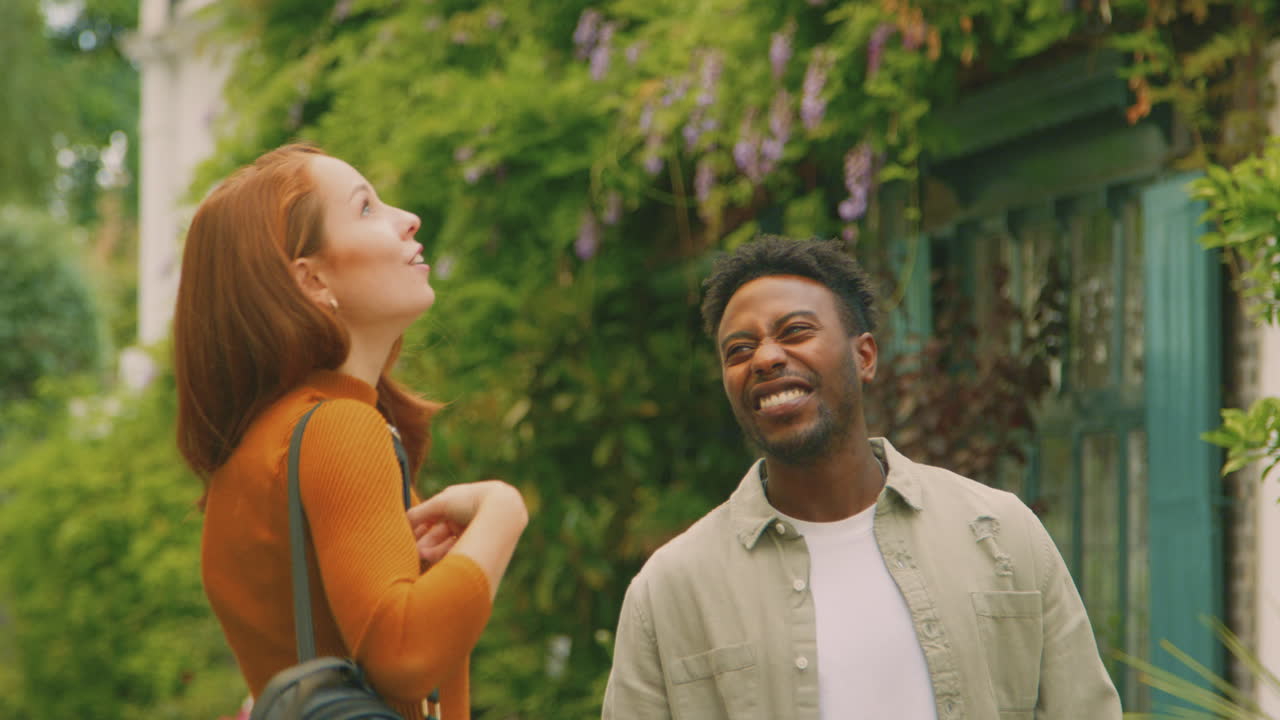 Young Couple Of Vloggers Or Social Influencers Travelling Through City Street For Social Media
