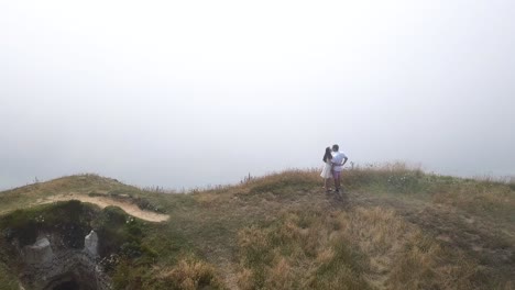 couple enjoying a foggy vista from a cliff