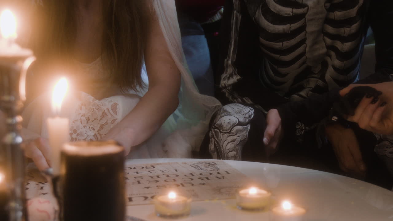 Spooky Halloween Gathering with Spirit Board and Costumes