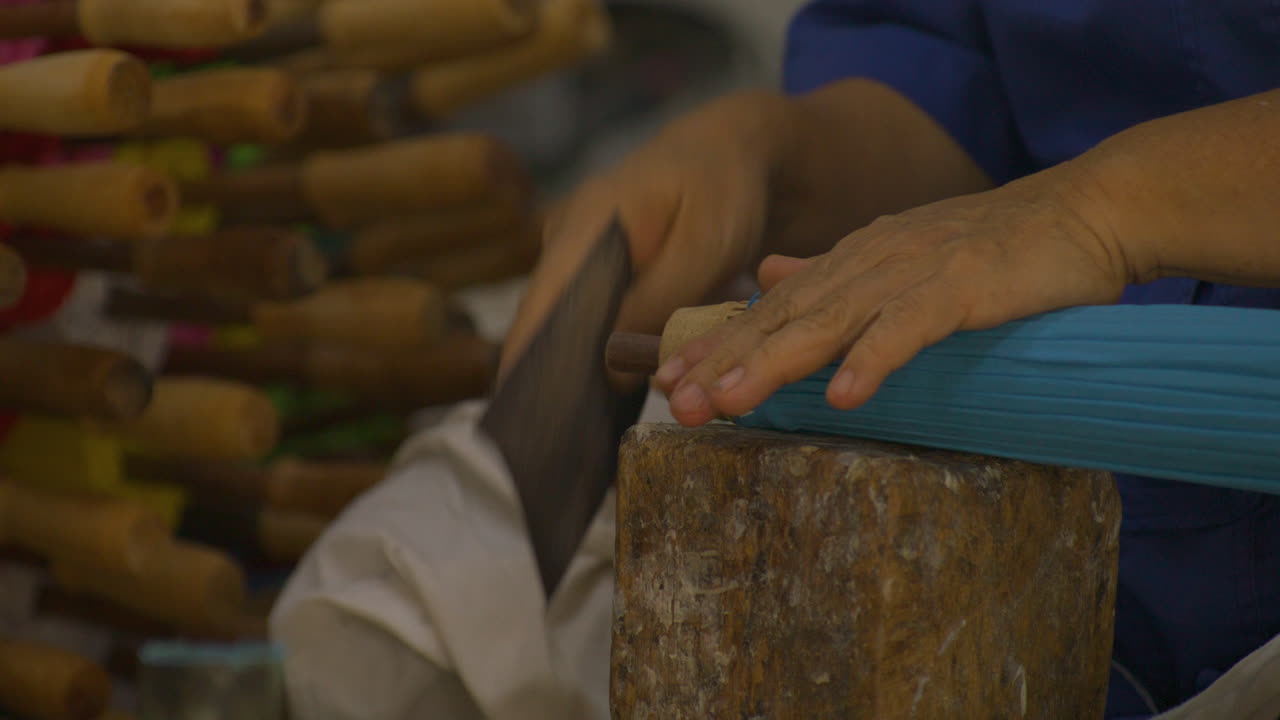 Close-up of the interesting process of making traditional oil-paper umbrellas.