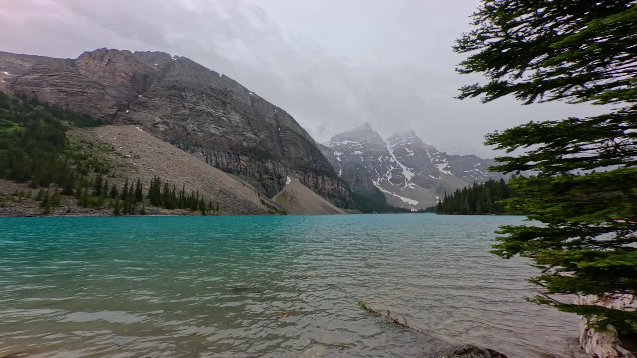 Lake side view of the beautiful azure blue waters of Moriane Lake in Banff National Park in Alberta Canada