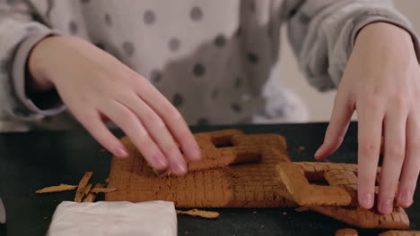 child building a gingerbread house