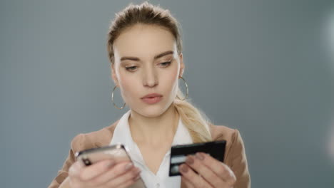 business woman typing credit card number on mobile phone for online shopping