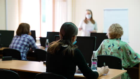 female students taking records of medical lecture. university course on ophthalmology and eye surgery.