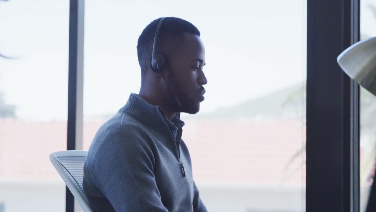 Man with headset working on computer