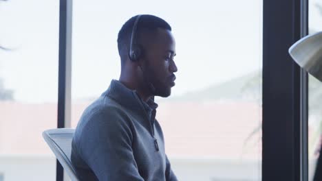man with headset working on computer