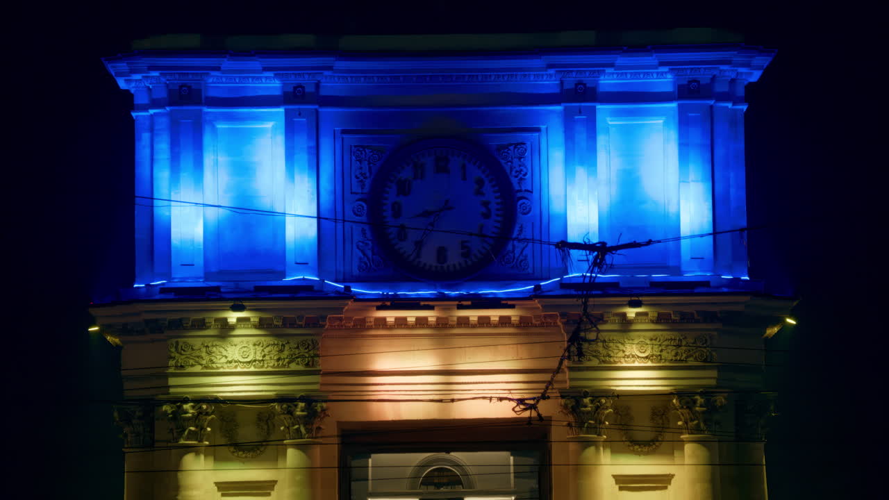 The flag of Ukraine projection on the facade of The Triumphal Arch in the evening