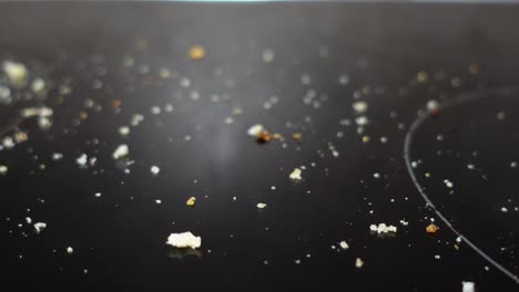 close-up of bread crumbs on a dirty stovetop