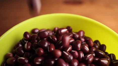 Detail-of-red-bean-dropping-on-a-green-bowl