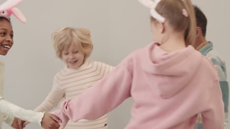 multiethnic kids round dancing on easter