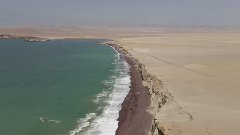 Aerial-flight-where-Pacific-ocean-meets-featureless-desert-in-Peru