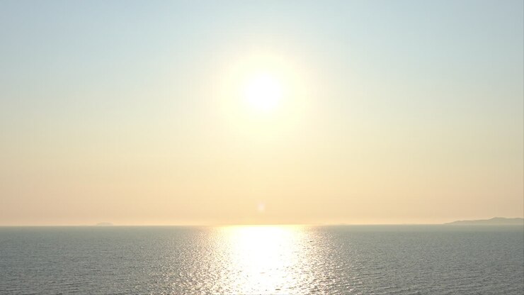 Amazing golden color sunset over the calm ocean aerial