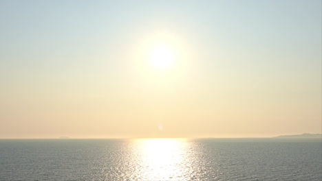 amazing golden color sunset over the calm ocean aerial