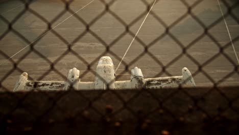 slow-motion-top-shot-of-half-airplane-on-ground-behind-barbed-wire-netting,-old-abandoned-airplane-cinematic-establishment-shot,-Athens-Elliniko-airport-loneliness