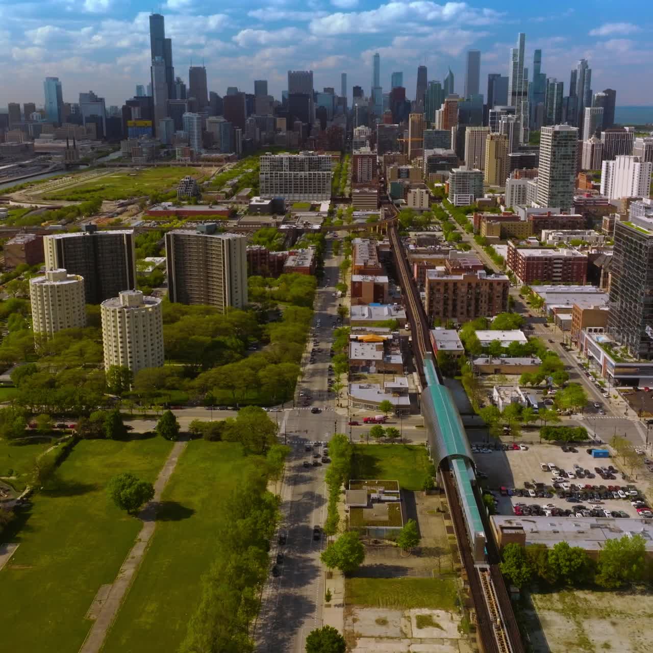 Beautiful scenic picture of modern Chicago on sunny daytime. Drone descending over the underground railways. Skyscrapers at backdrop