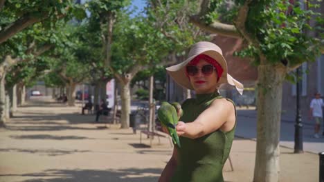 stunning video of parrots eating seeds from the hand of a caucasian girl in green dress with a knitted hat