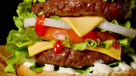 Closeup-of-home-made-beef-burgers-with-lettuce-and-mayonnaise-served-on-little-wooden-cutting-board.-Dark-background