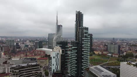 modern downtown and skyscrapers of milan city, aerial orbit view