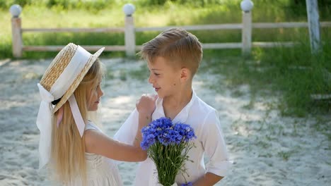 brother and sister at the pond on a sunny day, happy children, summer holidays for children, children have fun by the river