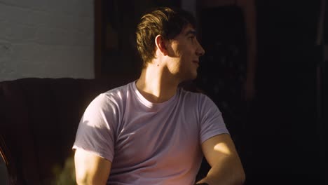 guy watches girlfriend dance laughs and smiles to himself