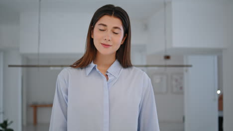 confident entrepreneur posing office hall closeup. smiling woman raising eyes