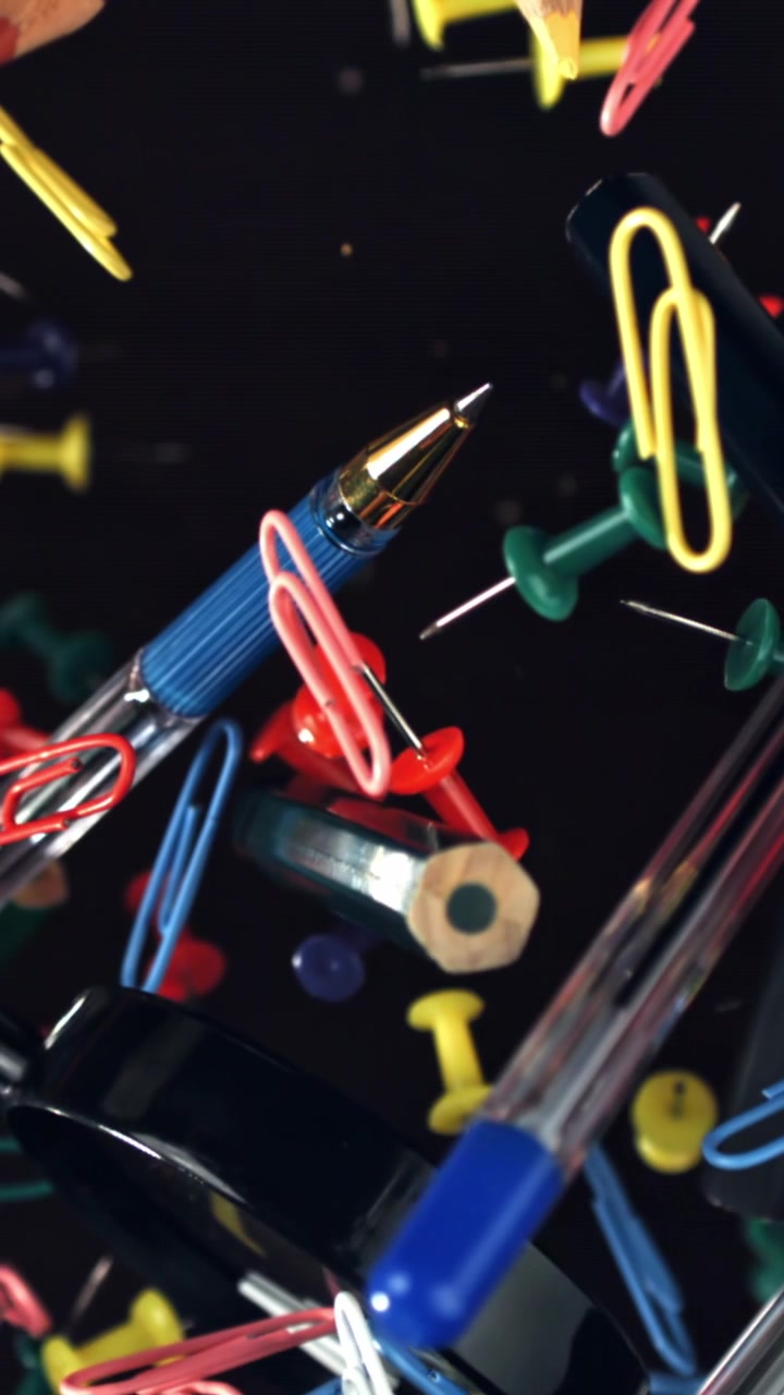 Colorful Office and School Supplies Floating on Black Background