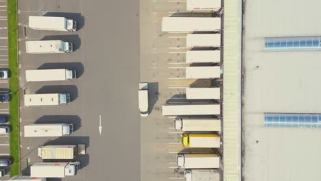 Aerial-drone-view-of-group-of-large-modern-industrial-warehouse-or-factory-buildings-in-suburban-city-area