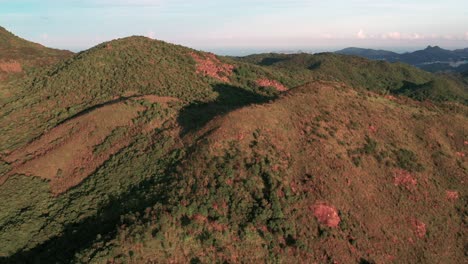 Peaks-cast-long-shadows-on-Ma-On-Shan-Mountains-Hong-Kong,-aerial-orbit